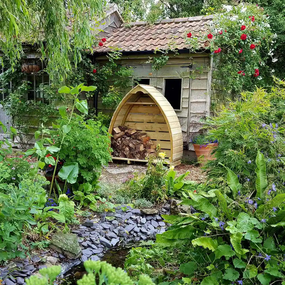 Little Arched Timber Log Store in the garden