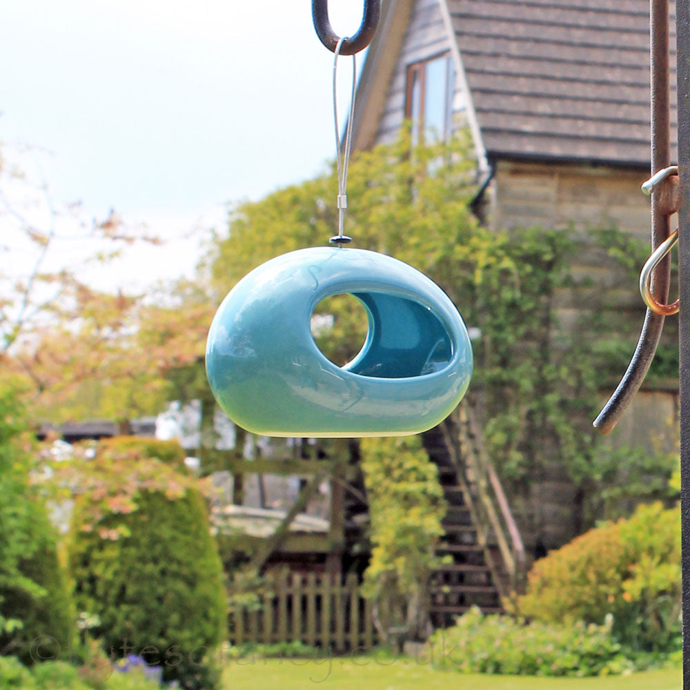 Selo Hanging Blue Ceramic Water Dish in the garden