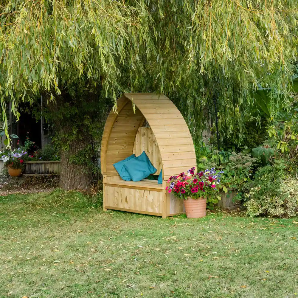 Arched Garden Arbour under the willow tree with bright cushions